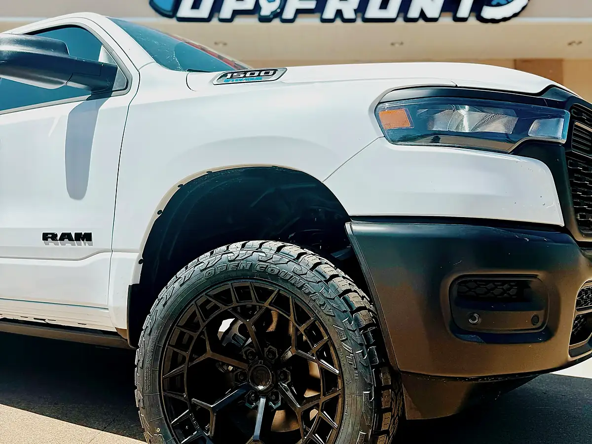 Front wheel of a white Ram 1500 on a 3.5 inch Rough Country lift with a 22 inch bronze Fuel wheel and 33 inch tire