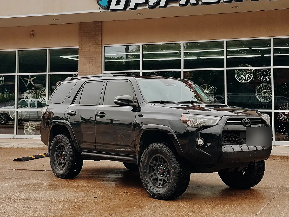 Black 2024 Toyota 4Runner on a 2 inch lift kit with bronze wheels outside the Wheels Up Front shop in Tyler