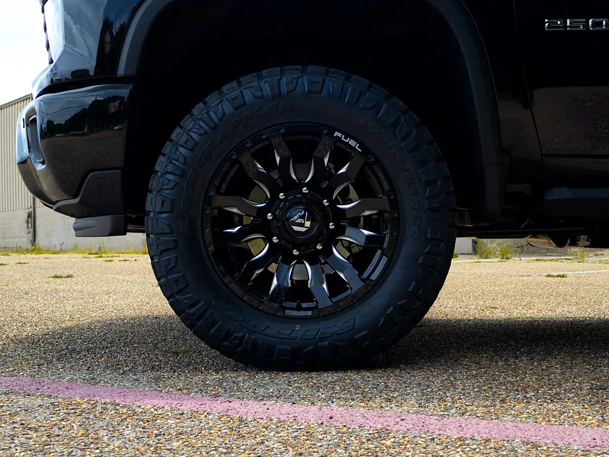 Black 2026 Chevy Silverado 2500 with a level kit on Fuel Blitz wheels and Nitto Ridge Grappler tires