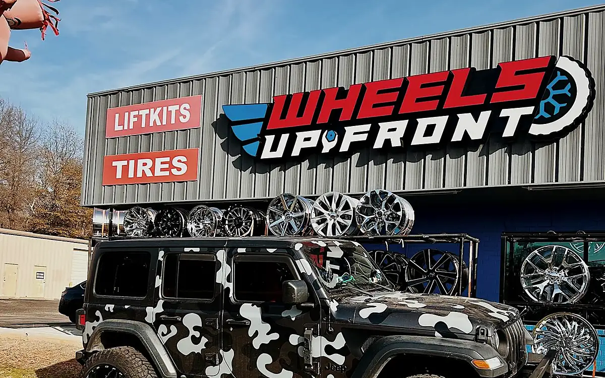 The Wheels Up Front shop on Spur 63 in Longview, Texas, with its wall of wheels