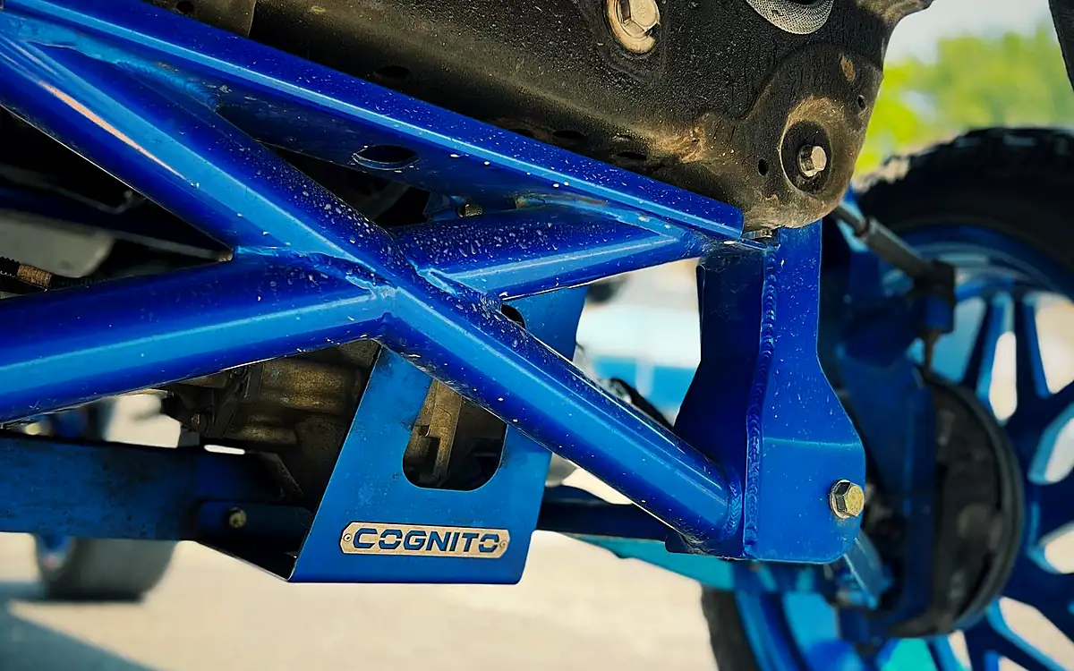 Blue Cognito control arms and front suspension under a lifted truck at Wheels Up Front