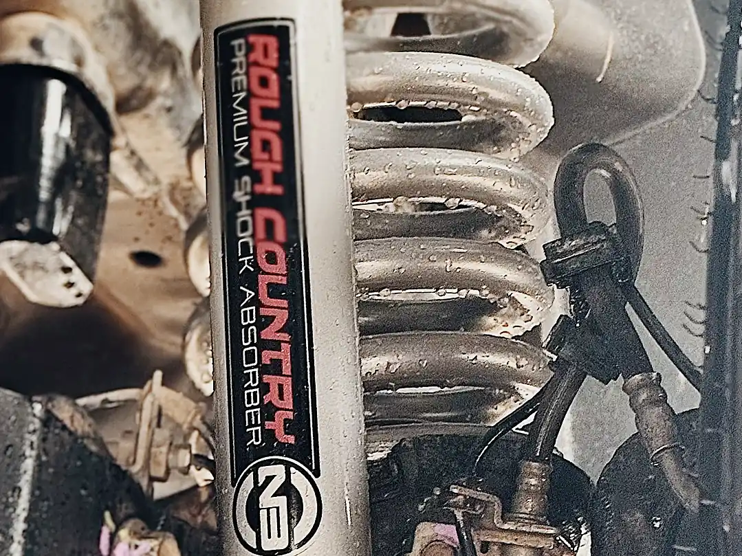 Rough Country N3 shock absorber mounted next to the coil spring on a truck at the Wheels Up Front Tyler shop