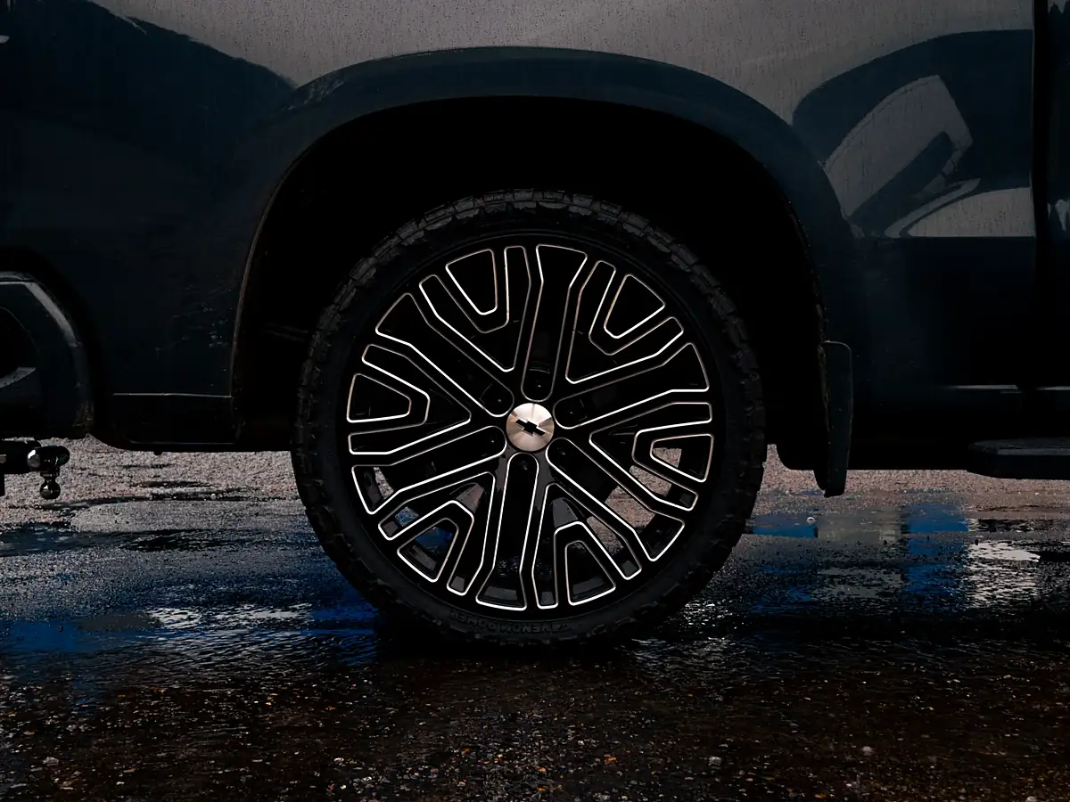 Rear wheel of the leveled Silverado on a 24 inch black and milled wheel