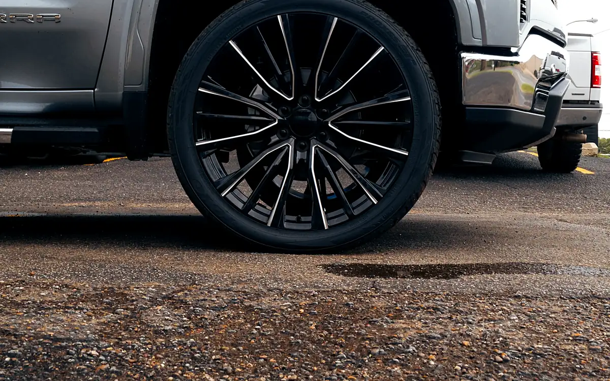 Front wheel of a brand new 2026 GMC Sierra 1500 Duramax with a 2 inch level kit and 24 inch wheels