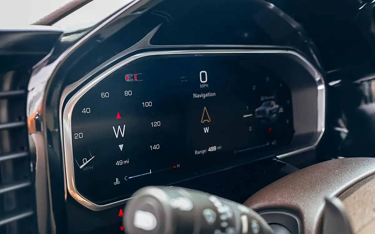 Digital dash of a new GMC Sierra 1500 showing 49 miles on the odometer