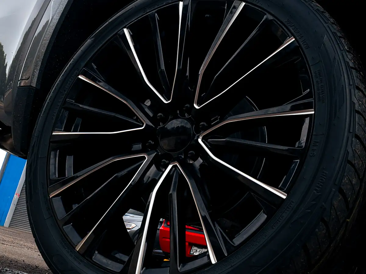 24 inch black and machined wheel with a red brake caliper on the leveled 2026 GMC Sierra 1500