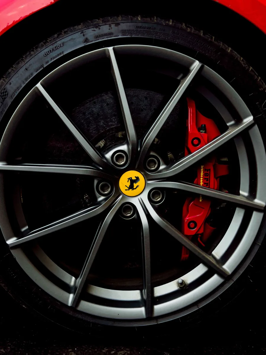 Alloy wheel with a red brake caliper visible through the spokes