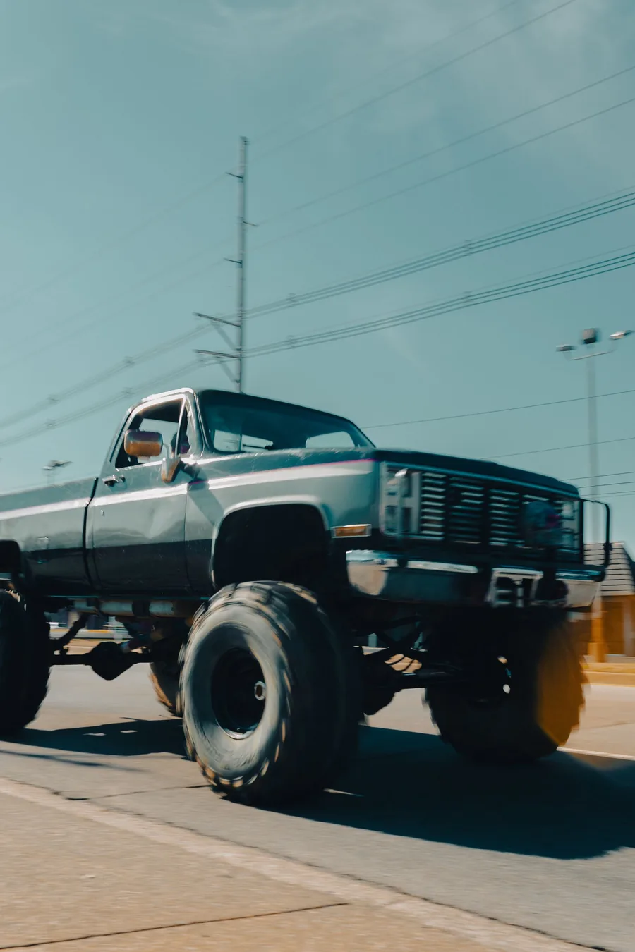 Classic square-body pickup riding high on oversized off-road tires