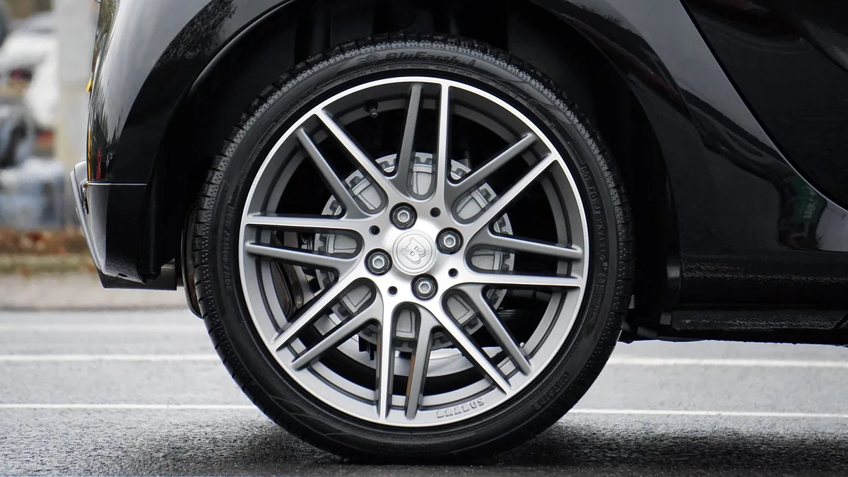 Silver multi-spoke alloy wheel mounted on a black car